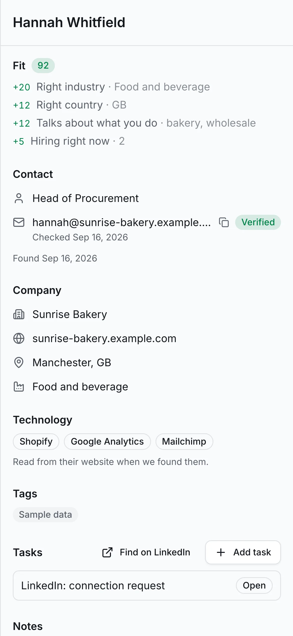 A lead record showing verified email, fit score with reasons, technologies and hiring, on a phone
